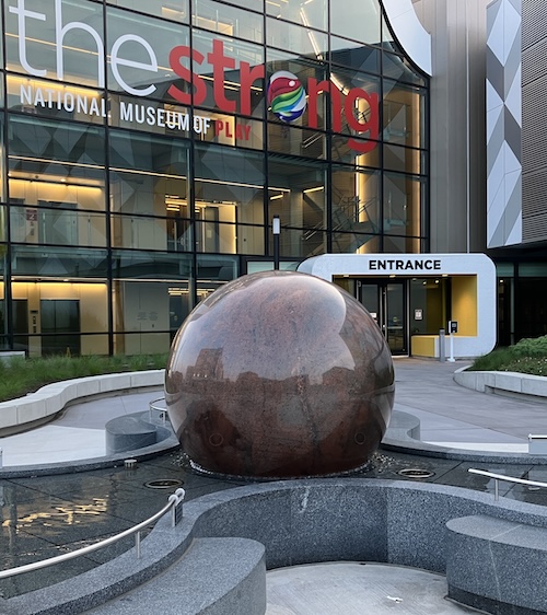 The entrance to the Strong Museum. In the foreground is a fountain with a ten-ton granite sphere.