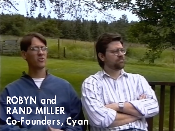 Robyn and Rand Miller sitting on a bench outdoors, circa 1993. The image quality is much improved.